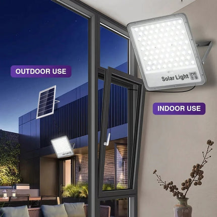 Solar light fixture with outdoor and indoor usage labels on a modern building exterior.