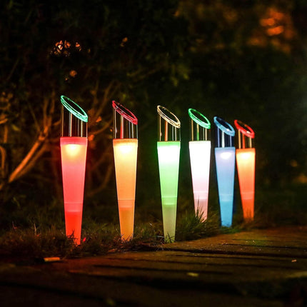 Colorful LED lights on stands in a garden setting