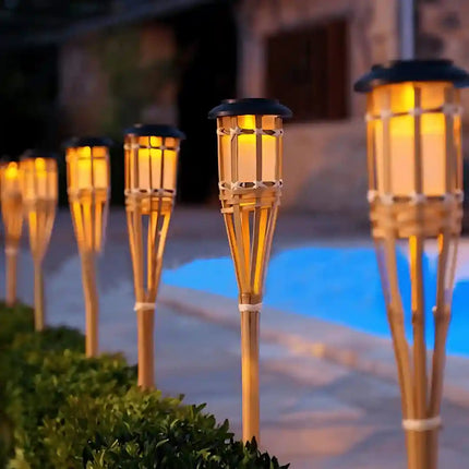 Solar bamboo tiki torch light with flickering flame effect.