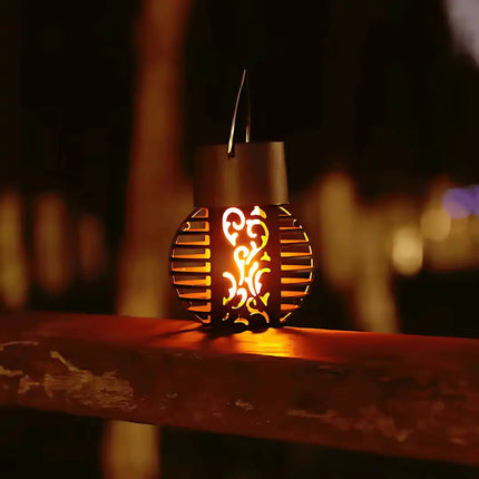 Hanging solar flame lantern for outdoor garden and patio decor.